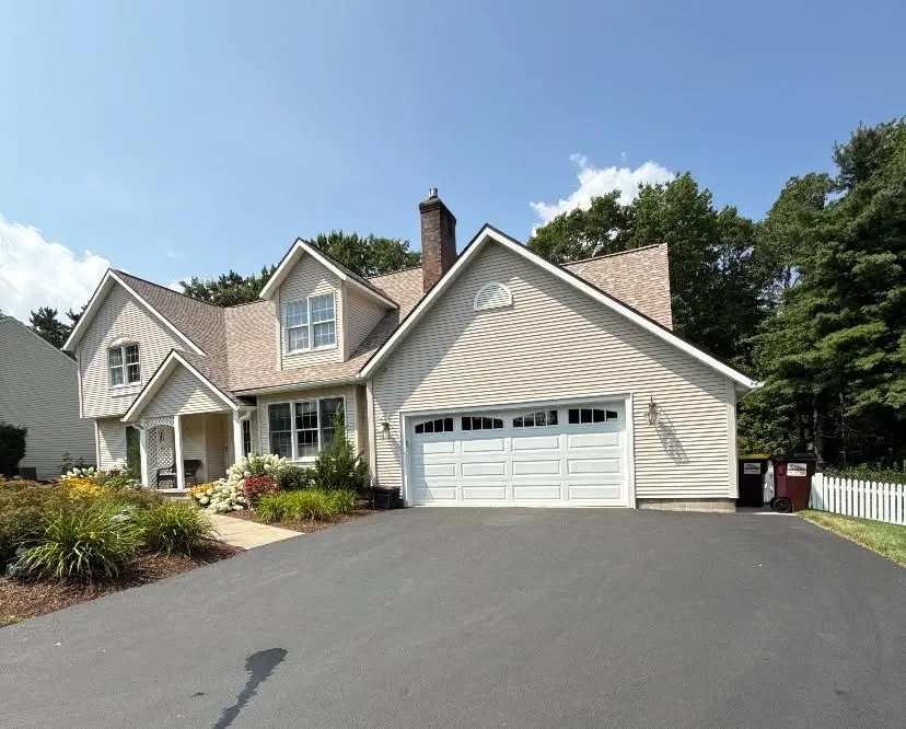 White double garage door on a landscaped two-storey home